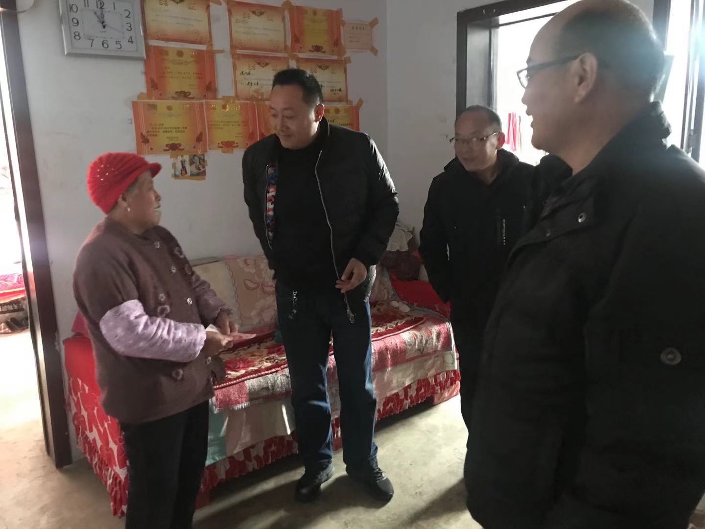 图为峄城区扶贫开发领导小组走访慰问帮扶户并送去慰问金。