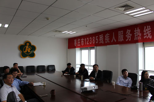 图为考察组一行在观看我市残疾人综合康复中心建设情况